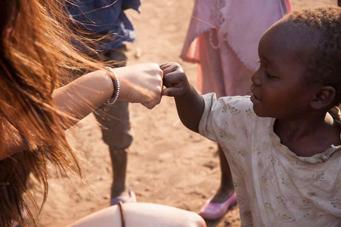 Malawi-Orbis-making-friends-child-fistbump-684w
