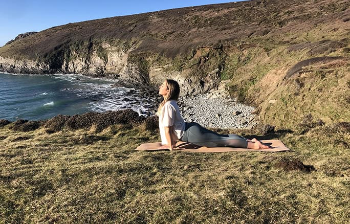 Wales-Adventure-Tours-UK-Yoga-Surf-Retreat-clifftop upward dog