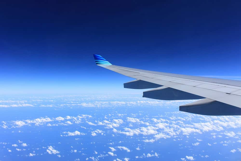 How to Reduce your carbon footprint in travel. Plane wing, Unsplash